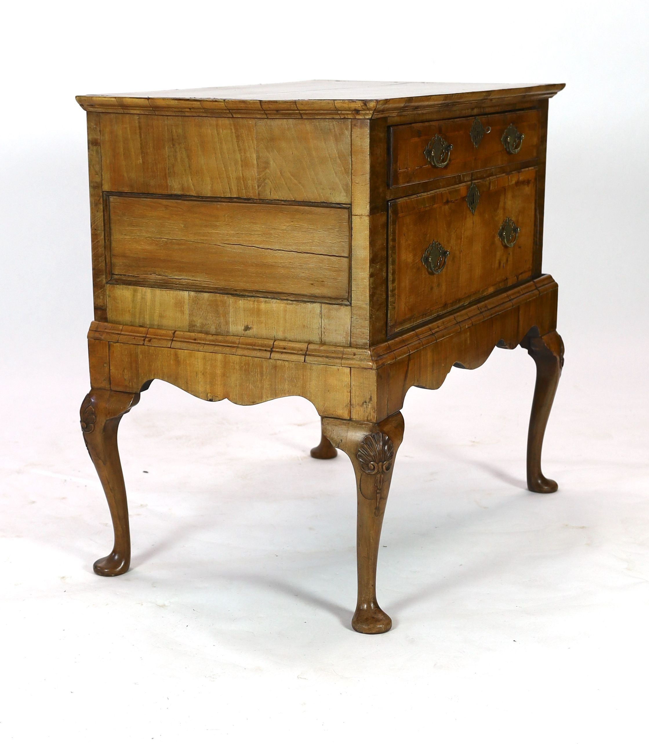 A mid 18th century featherbanded walnut chest on stand, with moulded quarter veneered top, one long and one deep drawer, on stand with shell kneed cabriole legs and pad feet, width 96cm depth 62cm height 93cm